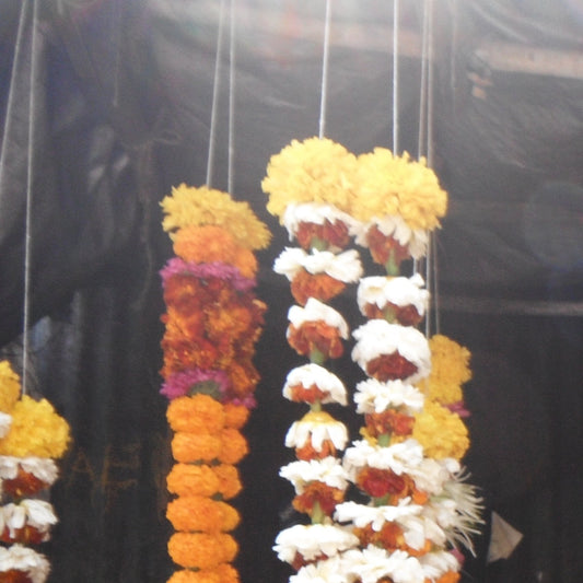 Hanging strands of white flowers and orange and yellow marigolds